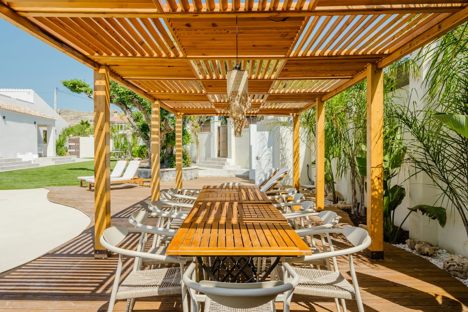 Light wood pergola over an outdoor dining table